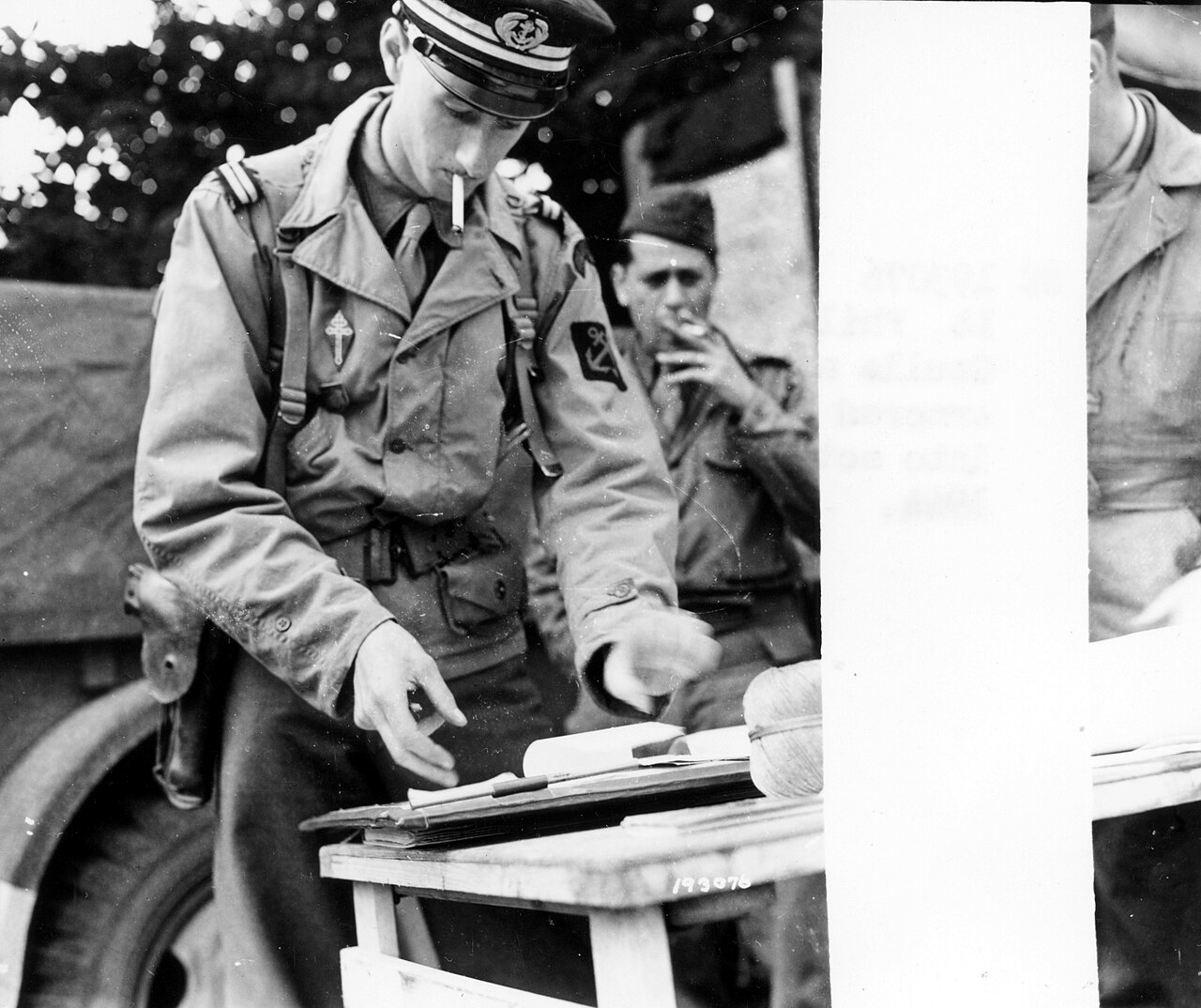 SC 193076 - Pt. Phillipe De Gaulle, son of General De Gaulle and an officer of the 2nd French Armored Division, checks maps before going into action, somewhere in France. 16 August