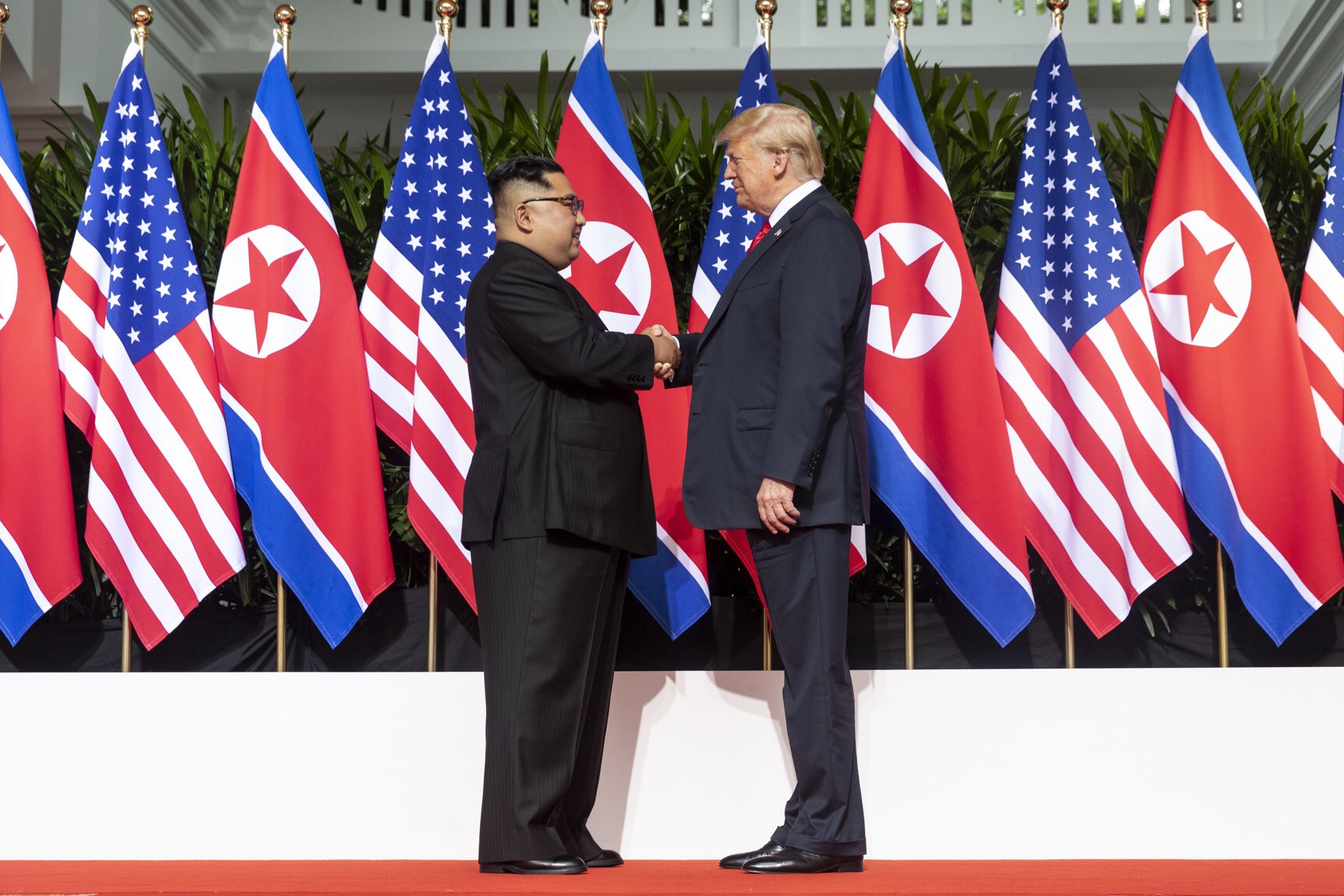 Kim and Trump shaking hands at the red carpet during the DPRK–USA Singapore Summit — archival photograph